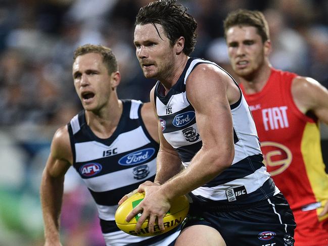 Patrick Dangerfield (centre) and Joel Selwood (left) of the Cats are seen in action during the round 6 AFL match between the Geelong Cats and the Gold Coast Suns at Simonds Stadium in Geelong, Saturday, April 30, 2016. (AAP Image/Julian Smith) NO ARCHIVING, EDITORIAL USE ONLY