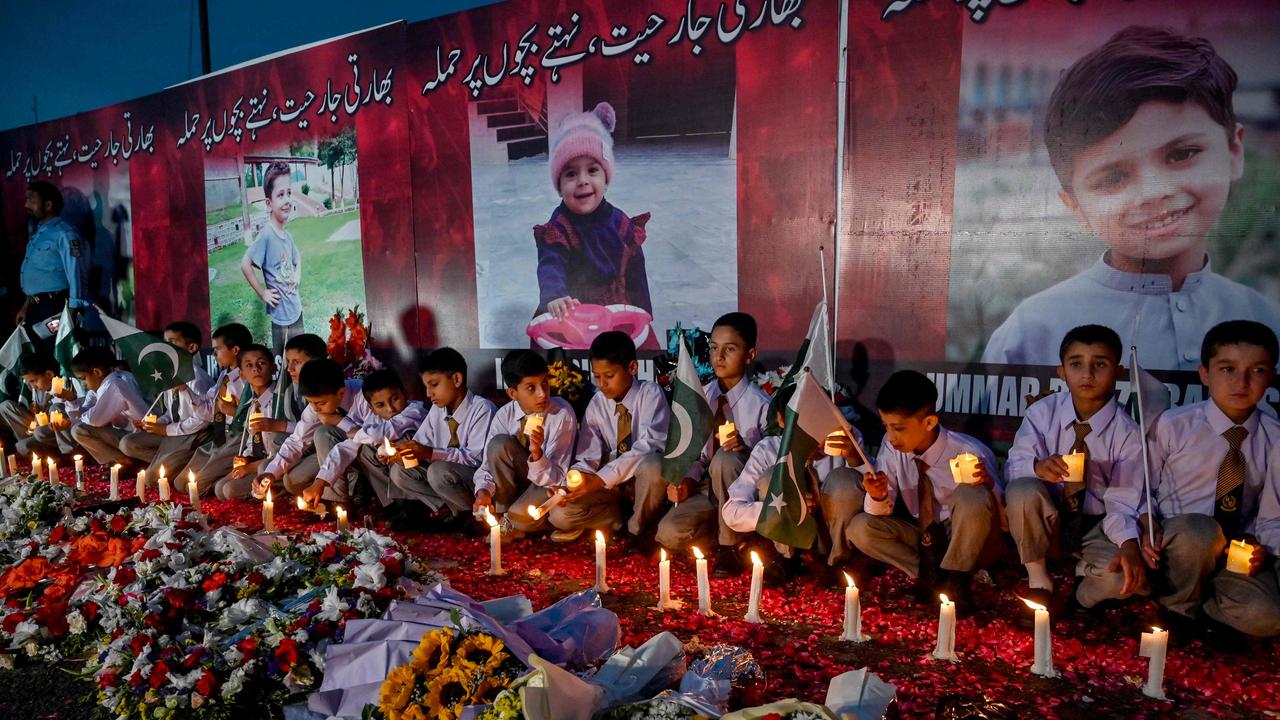 Children hold candles during a ceremony for victims of an Indian missile strike in Islamabad. Picture: Farooq Naeem/AFP