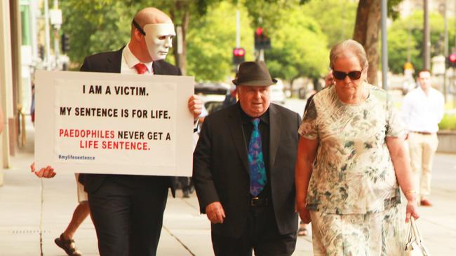 Brother B, left, walks alongside Vivian Frederick Deboo and his wife Margaret in November 2018. Picture: Supplied