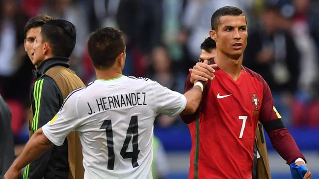 Mexico's forward Javier Hernandez (L) shakes hands with Portugal's forward Cristiano Ronaldo