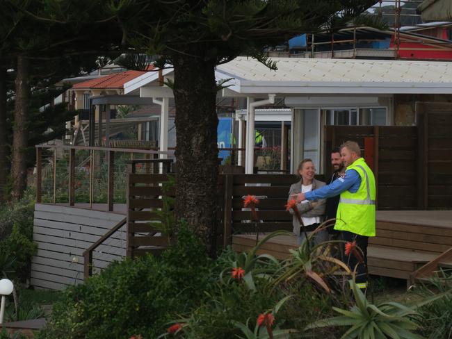 A state government engineer talks to residents. Picture: Richard Noone