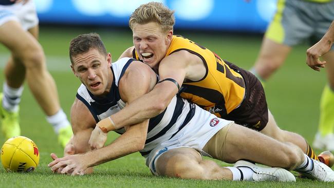 Hawthorn’s James Sicily brings down Joel Selwood in a tackle. Picture: Michael Klein