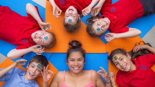 Kylee Mason with Sacred Heart Primary School Students L-R Liam, India, Sienna, Holly and Maddy. International WomenÕs Day is about womenÕs pay gap across their life. Kylee used to work full-time then had kids and has just started up a new business teaching yoga in schools and to kids in gyms. Picture: Jason Edwards