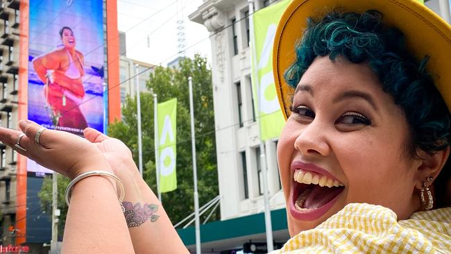 Content creator, activist and model April Hélène-Horton admiring herself on a national billboard.