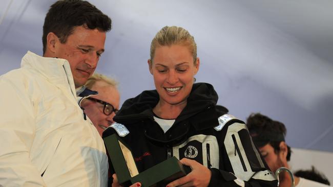 Kristy Hinze-Clark, joint owner of Sydney Hobart Yacht Race winner Comanche, receives the Rolex medallion  at the race finish in Hobart, Monday, Dec. 28, 2015. (AAP Image/Rob Blakers) NO ARCHIVING