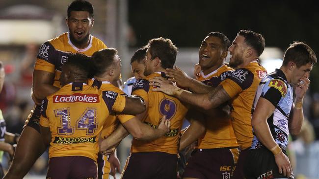 Jake Turpin celebrates with Broncos teammates after scoring the matchwinning try against Cronulla. Picture: Getty Images