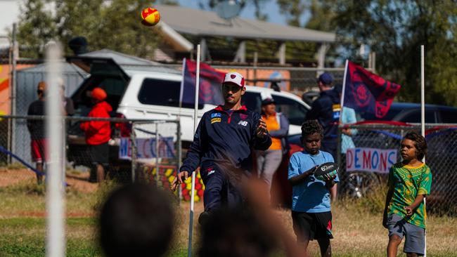 Melbourne Demons players Shane McAdam and Andy Moniz-Wakefield went to Santa Teresa ahead of the 2025 AFL game in Alice Springs. Picture: Melbourne Demons