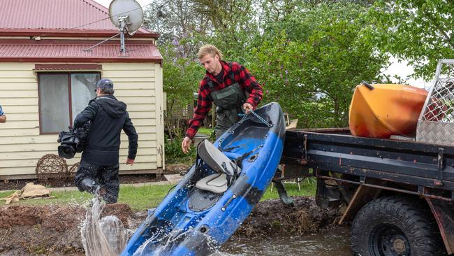 Flooding around the Macalister River flowing out of Lake Glenmaggie, township of Tinamba. Sandbagged General Store. Dan OÃ&#149;Connor (blue shirt and waders) and Riley Davis (red shirt and waders) Picture: Jason Edwards