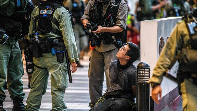 A protester is detained by police during a rally against a new national security law in Hong Kong. Picture: Anthony Wallace / AFP.