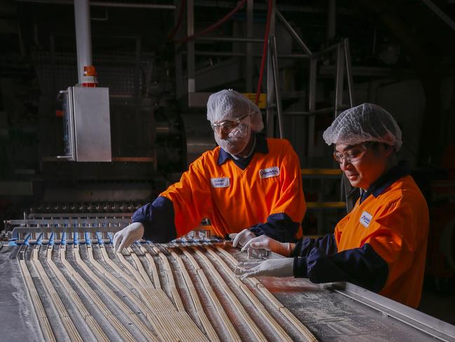 Cadbury's Picnic Bar Turns 60.Pictures taken on the production line at the Cadburys factory in Ringwood. Picnic production line workers Gurmit Sing and Han Cam.Picture by Wayne Taylor 27th August 2019