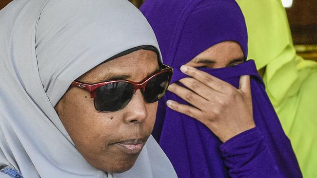 Zainab Abdirahman-Khalif (right) leaves the Supreme Court in Adelaide after being acquitted of terror charges. Picture: AAP Image/Roy Vandervegt