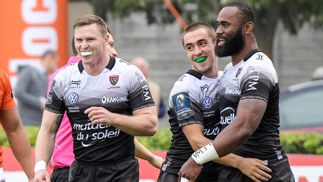 Semi Radradra is congratulated by RC Toulon's French scrumhalf Anthony Meric (C) after scoring a try.
