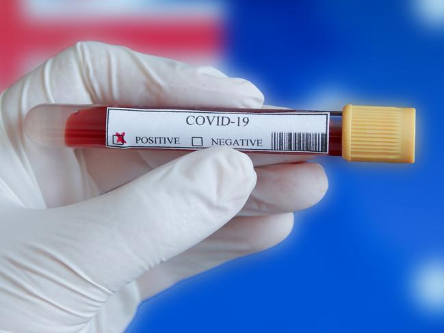 COVID-19 Pandemic Coronavirus concept ; Close-up of a Positive COVID-19 blood test sample tube with Flag of Australia at background. Blood testing for diagnosis new Corona virus infection.