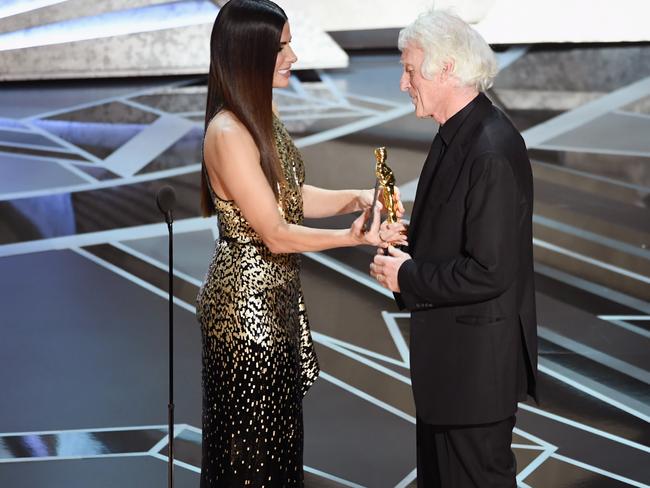Sandra Bullock presented cinematographer Roger A. Deakins with his Oscar. Picture: Getty Images