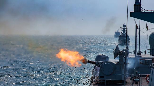 The guided-missile destroyer Shenzhen fires its close-in weapons system at mock sea targets in waters off the South China Sea.