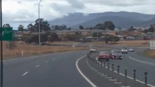 A screenshot from the dashcam footage show a car swerving out of the way to avoid a collision with another vehicle that is being driven on the wrong side of the Midland Highway. Image: facebook.com/nick.arnol