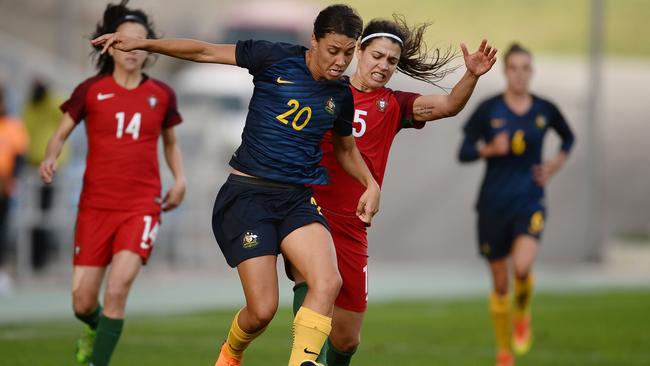 Sam Kerr tries to skip away from the Portugal defence.