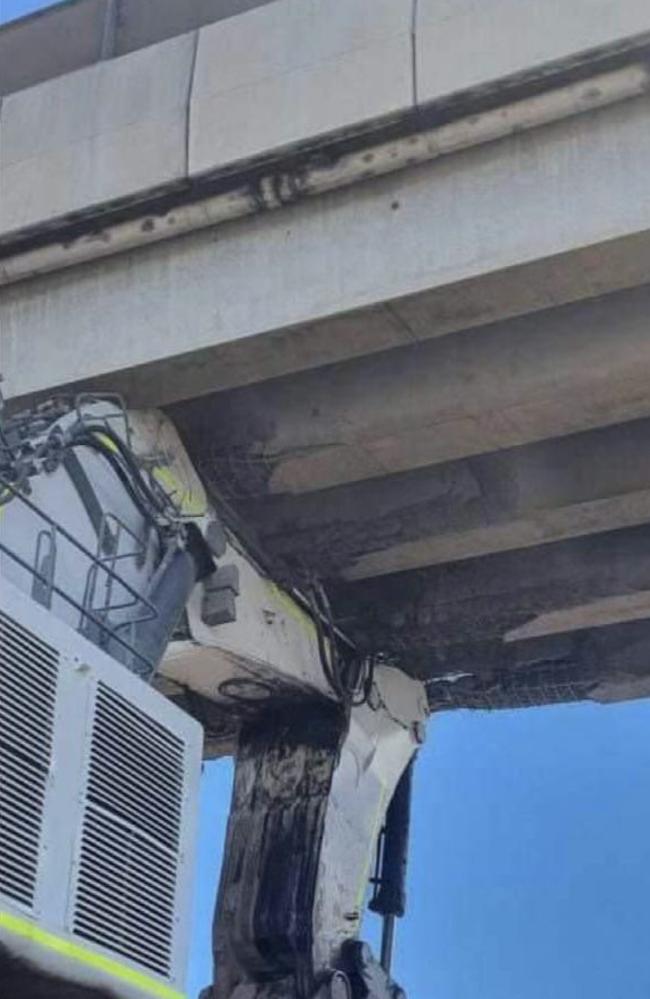 The Peak Downs Highway at near Caval Ridge mine remains closed after an excavator being moved on a mine road struck and damaged the overpass.