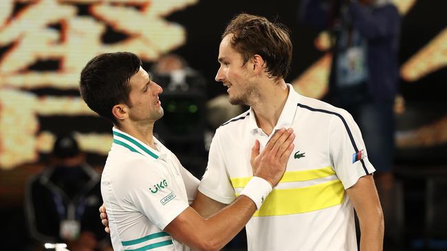 Novak Djokovic and Daniil Medvedev share a moment after the 2021 Australian Open final.