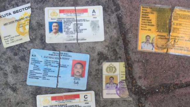 Identity cards belonging to police officer Wayan Sudarsa were found dumped by the side of the road in a white plastic bag.