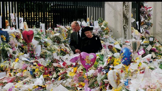 Queen Elizabeth II and Prince Philip, the Duke of Edinburgh view the floral tributes to Princess Diana at Buckingham Palace after Diana’s death in 1997.