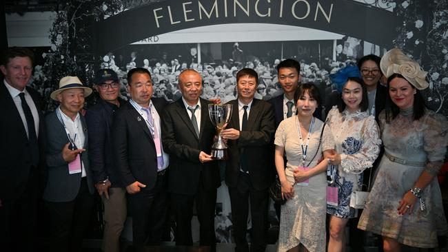 Trainer Matt Laurie (left) poses with Yuesheng Zhang (centre) and Yulong connections after Treasurethe Moment’s Oaks win at Flemington on Thursday. Picture: Vince Caligiuri / Getty Images