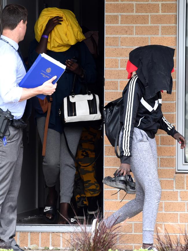 Police escort girls to the Werribee property to get belongings. Picture: Nicole Garmston