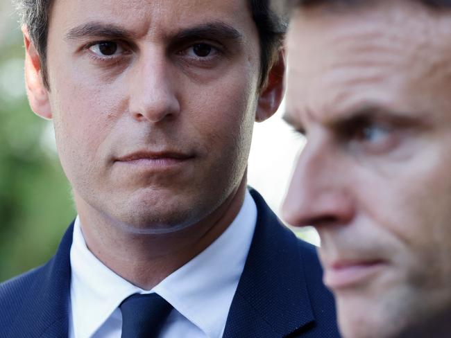 France's President Emmanuel Macron (right) stands next to Gabriel Attal, France’s new Prime Minister. (Photo by Ludovic MARIN / POOL / AFP)