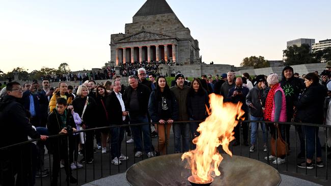 People gather at the eternal flame in front of the Shrine of Remembrance. Picture: AFP