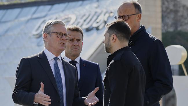 Keir Starmer talks to Volodymyr Zelensky as Emmanuel Macron and Friedrich Merz stand behind. Picture: Ludovic Marin via AP