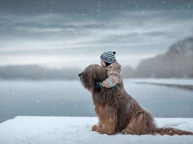 First snow ... Gregory and Crispy the Briard. Picture: Little Kids and Their Big Dogs