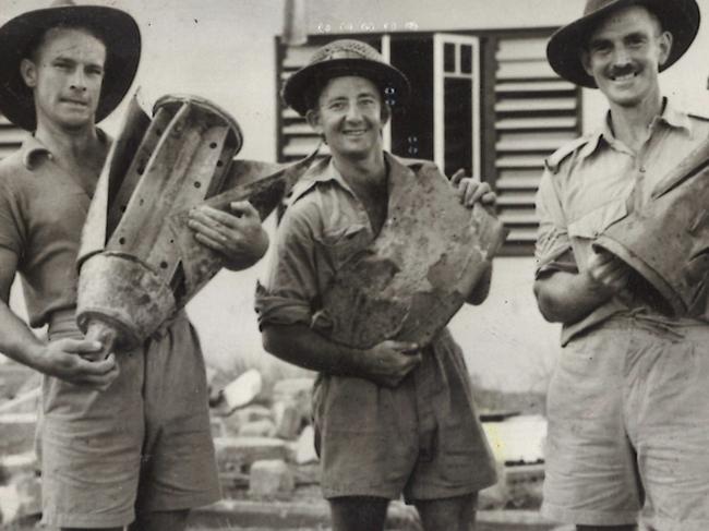 Pte F. Conlin of Sydney, Driver J. Hankin of Sydney, and Sergeant Babb of Balgownie are holding parts of Japanese bombs dropped during the raid on Darwin. WWII - World War II - Australia - Air raids - 1942-1943.