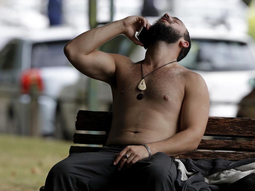 A man reacts as he speaks on a mobile phone outside a mosque in central Christchurch, New Zealand, Friday, March 15, 2019. (AP Photo/Mark Baker)