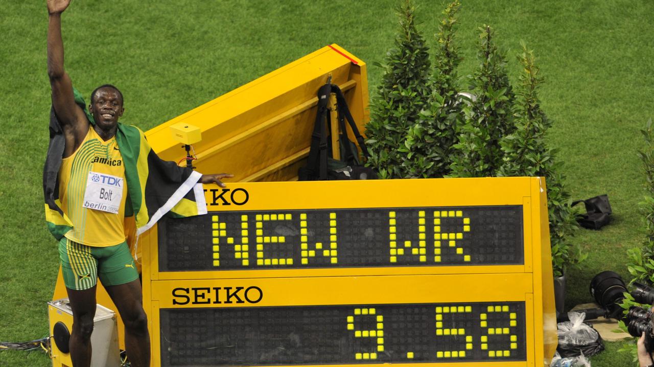 Jamaica's Usain Bolt poses beside the indicating board after setting a new Men's 100m World Record in the Men's final at the World Athletics Championships in Berlin on Sunday, Aug. 16, 2009. (AP Photo/Gero Breloer)