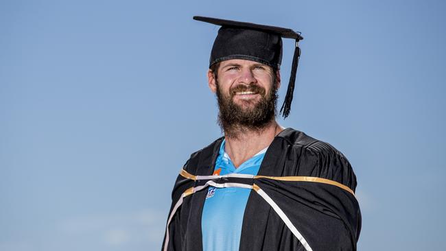 Gold Coast Titan Anthony Don has just got his masters degree. Anthony at Nobby Beach with Surfers Paradise skyline in the background. Picture: Jerad Williams