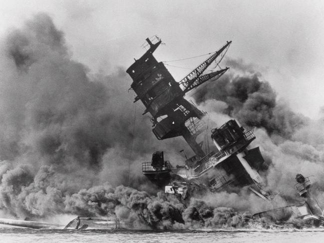 The battleship USS Arizona belches smoke as it topples over into the sea during a Japanese surprise attack on Pearl Harbor, Hawaii 07/12/1941.