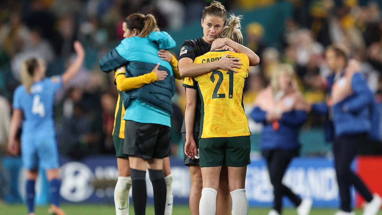 Aussie players embrace after the team's 1-3 defeat and elimination from the tournament. Picture: Brendon Thorne/Getty Images