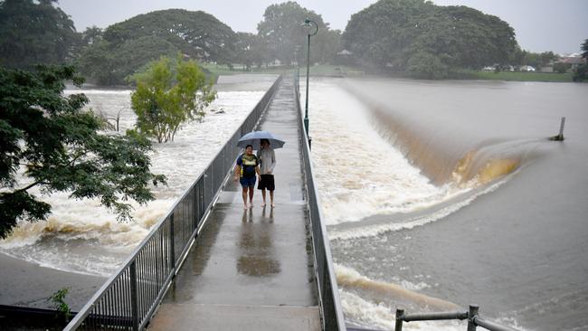 Flash flooding in Townsville after heavy overnight rain. Krystal Newton and Tallan Eliott (correct) at Aplins Weir. Picture: Evan Morgan