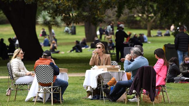 People have a picnic in a park in Melbourne on Sunday. Picture: AFP