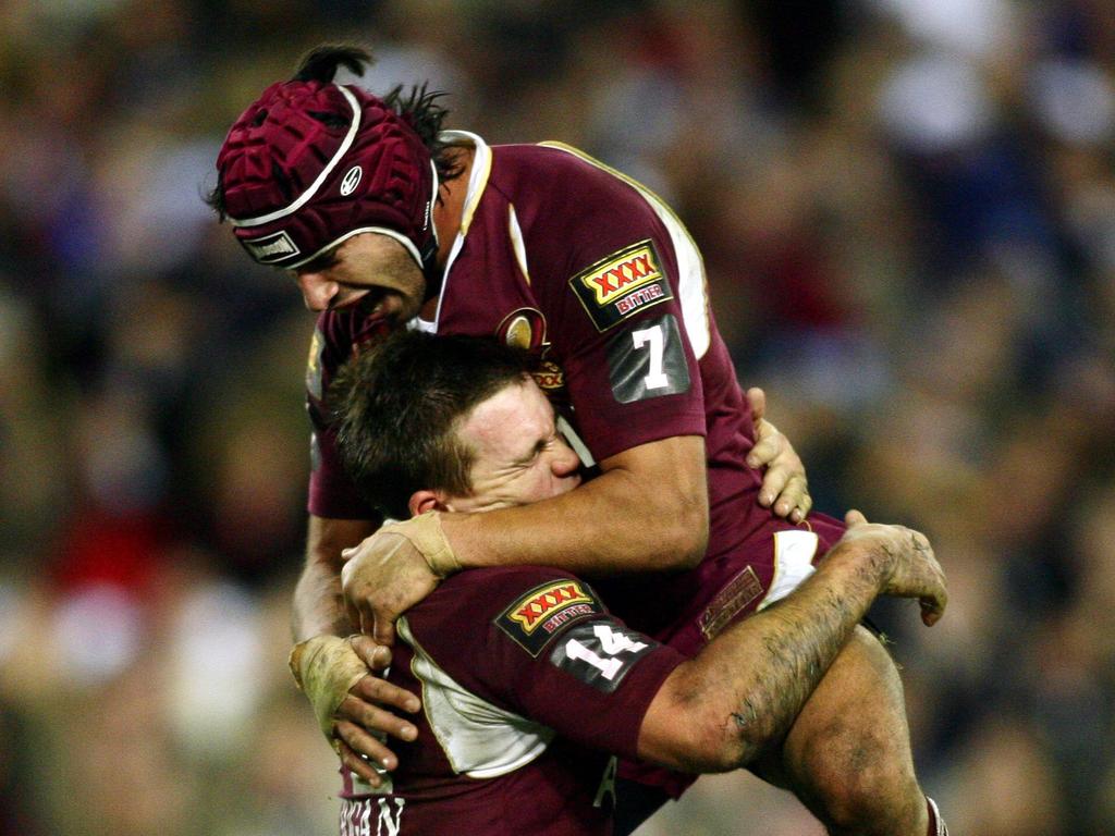 Johnathan Thurston hugs Shaun Berrigan.