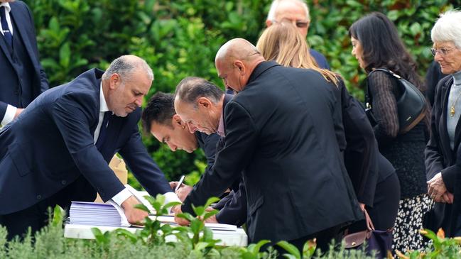 Mourners sign the guest book upon entry. Picture: NCA NewsWire