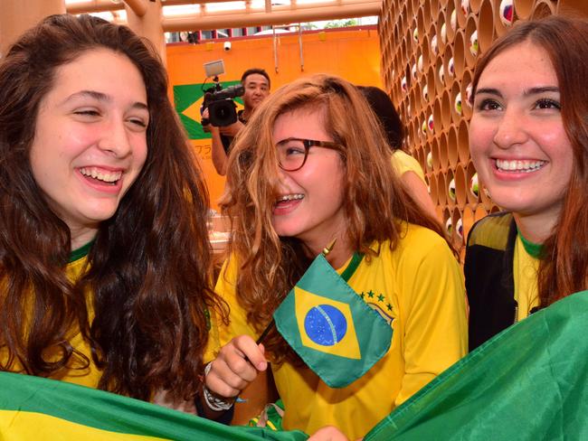 Brazilian and Japanese football fans celebrate the victory of Brazilian team against Croatia at the opening game of the 2014 FIFA World Cup at a breakfast meeting after the game at the Brazilian embassy in Tokyo on June 13, 2014. AFP PHOTO / Yoshikazu TSUNO