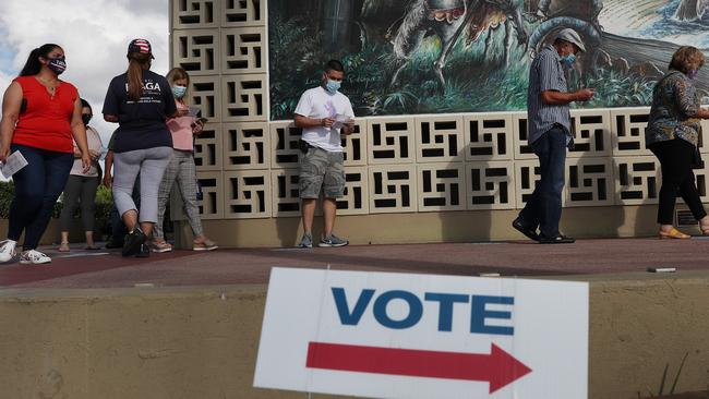 Voters wait in line to cast their early ballots at the Hialeah John F. Kennedy Library polling station on October 28 in Hialeah, Florida. Picture: AFP