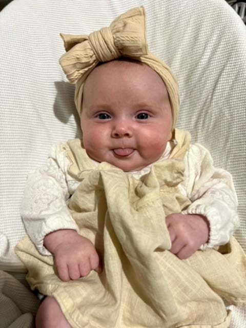 Amaiya Rai Bradford. Four months old. I have a very cheeky smile, I’m a giggler and love lying in my swing crib outside watching the trees.