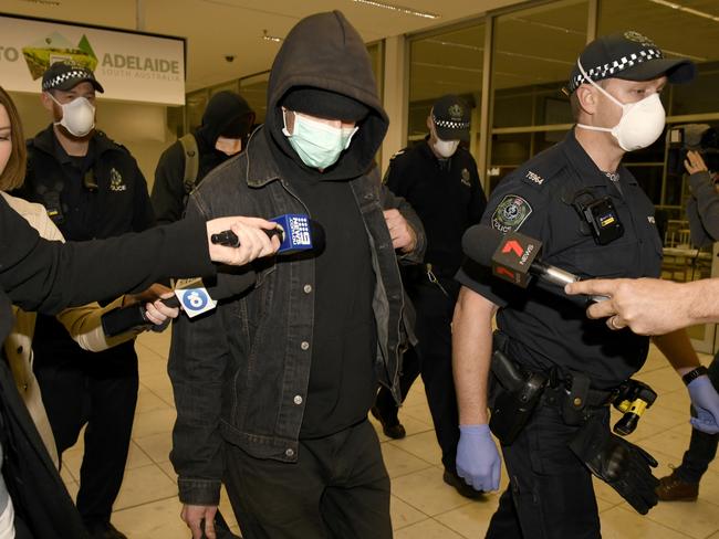 Four stowaways who attempted to enter Adelaide on a train were escorted by police at Adelaide Airport after staying at The Pullman Hotel for extradition on a flight to Melbourne this evening. Picture: NCA NewsWire/Naomi Jellicoe