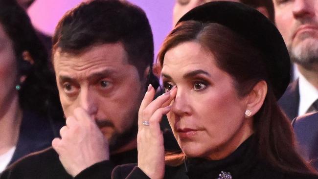 Ukrainian President Volodymyr Zelensky and Queen Mary of Denmark react as Janina Iwanska, a concentration camp survivor, delivers a speech during the commemorations.