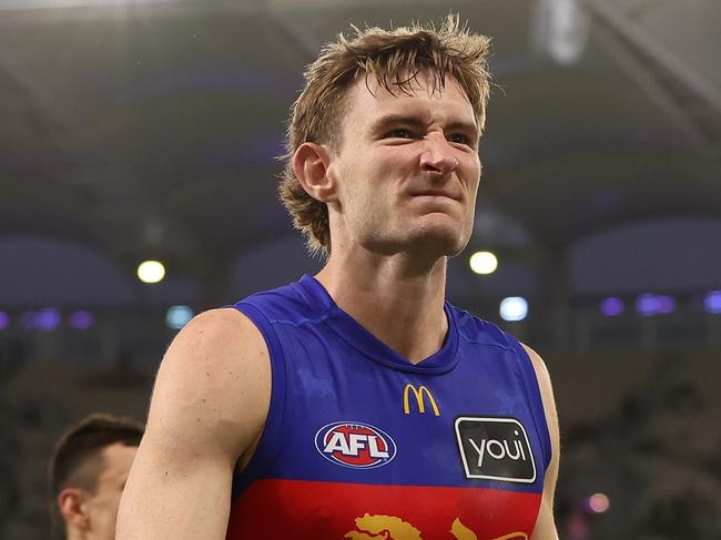 PERTH, AUSTRALIA - MARCH 17: Harris Andrews of the Lions leads the team from the field after being defeated during the round one AFL match between Fremantle Dockers and Brisbane Lions at Optus Stadium, on March 17, 2024, in Perth, Australia. (Photo by Paul Kane/Getty Images)