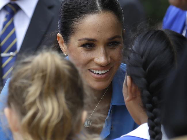 Meghan, Duchess of Sussex, talked with primary school students in Tonga. Picture: AP