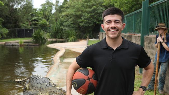 Freddy Webb shows off his basketball skills with monster croc, Speckles, at Crocodylus Park. Picture: Sam Lowe