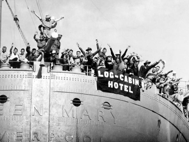 Farewell scenes aboard former cruise ship the Queen Mary as she leaves Sydney Harbour in October 1943. The Australian troops on board have their own ideas regarding a suitable name for the liner — the Log Cabin Hotel.